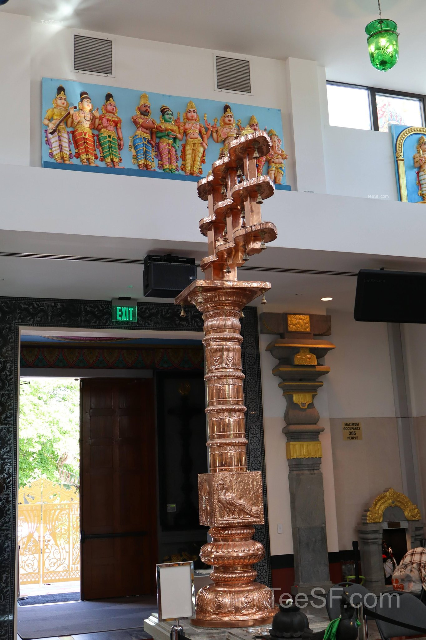 A tall temple lamp column rising through the interior hall.